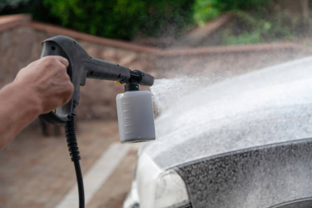 Hand sprays detergent with high pressure washer