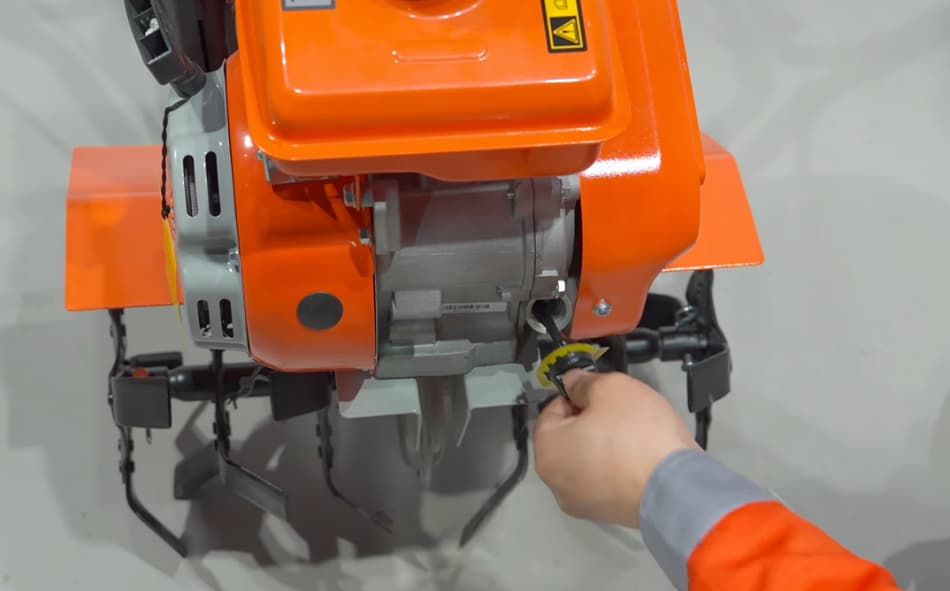 checking oil level on tiller engine dipstick